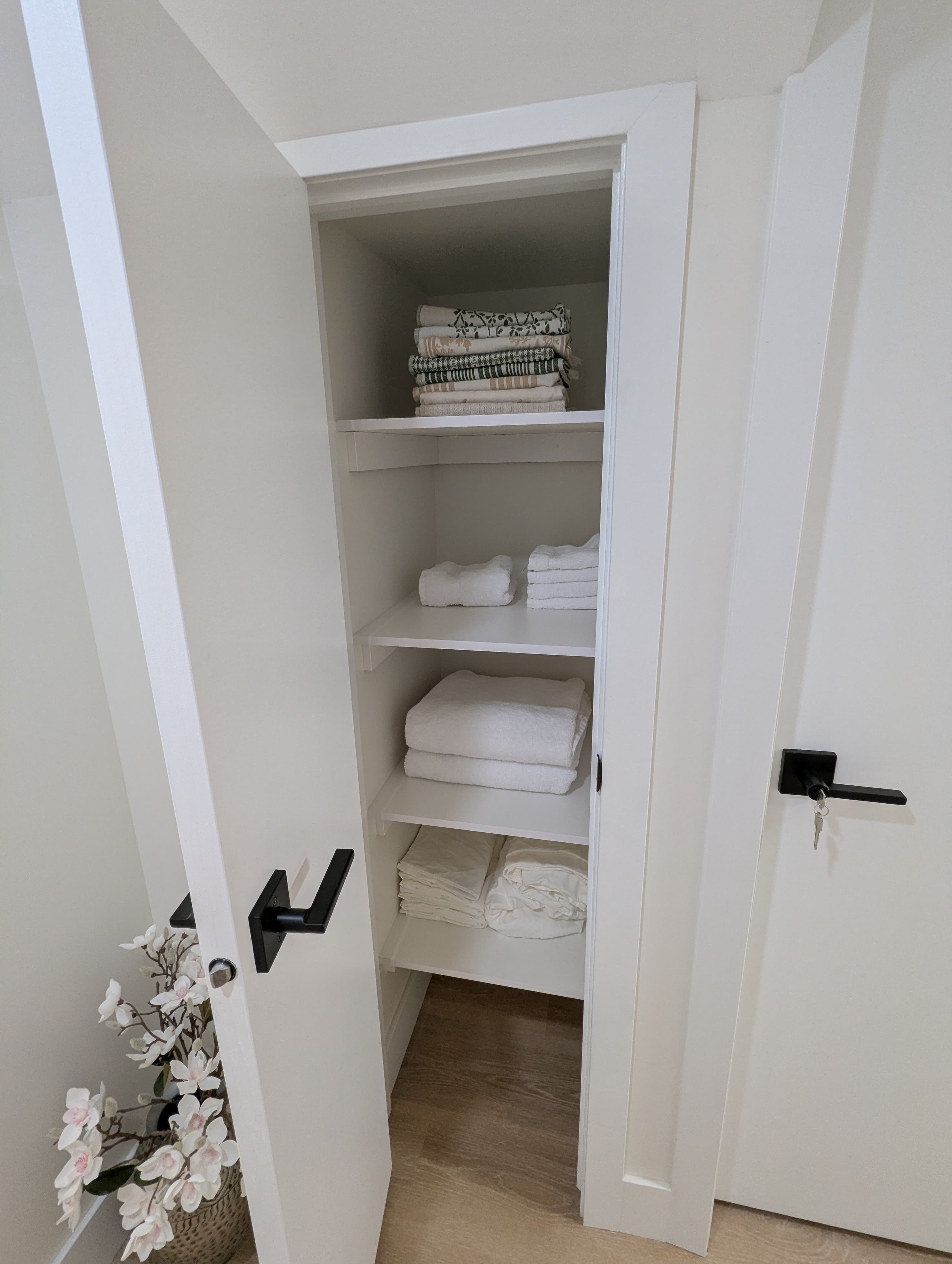 Linen closet with fresh towels and bedding