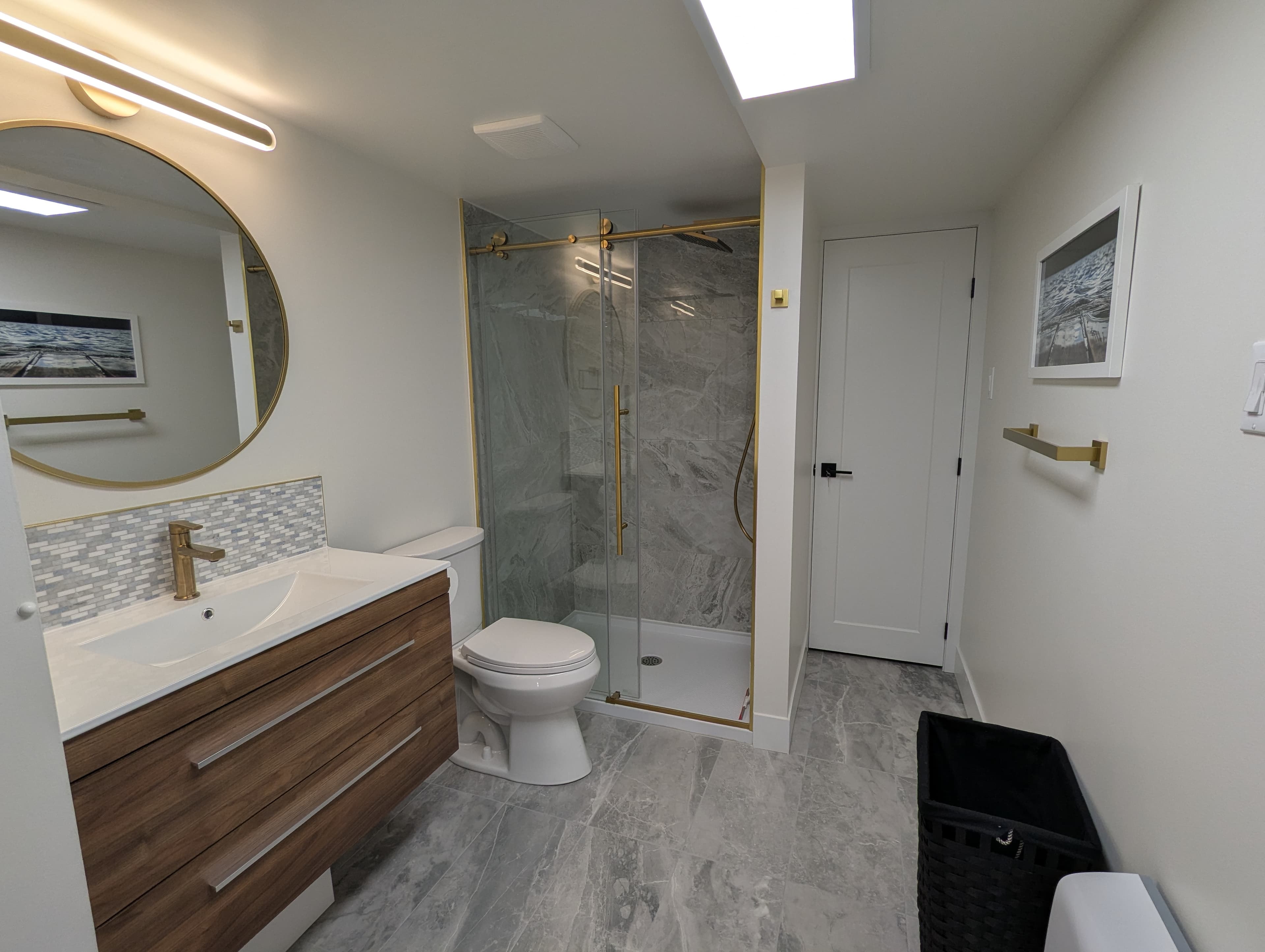 Bathroom with glass shower and gold fixtures