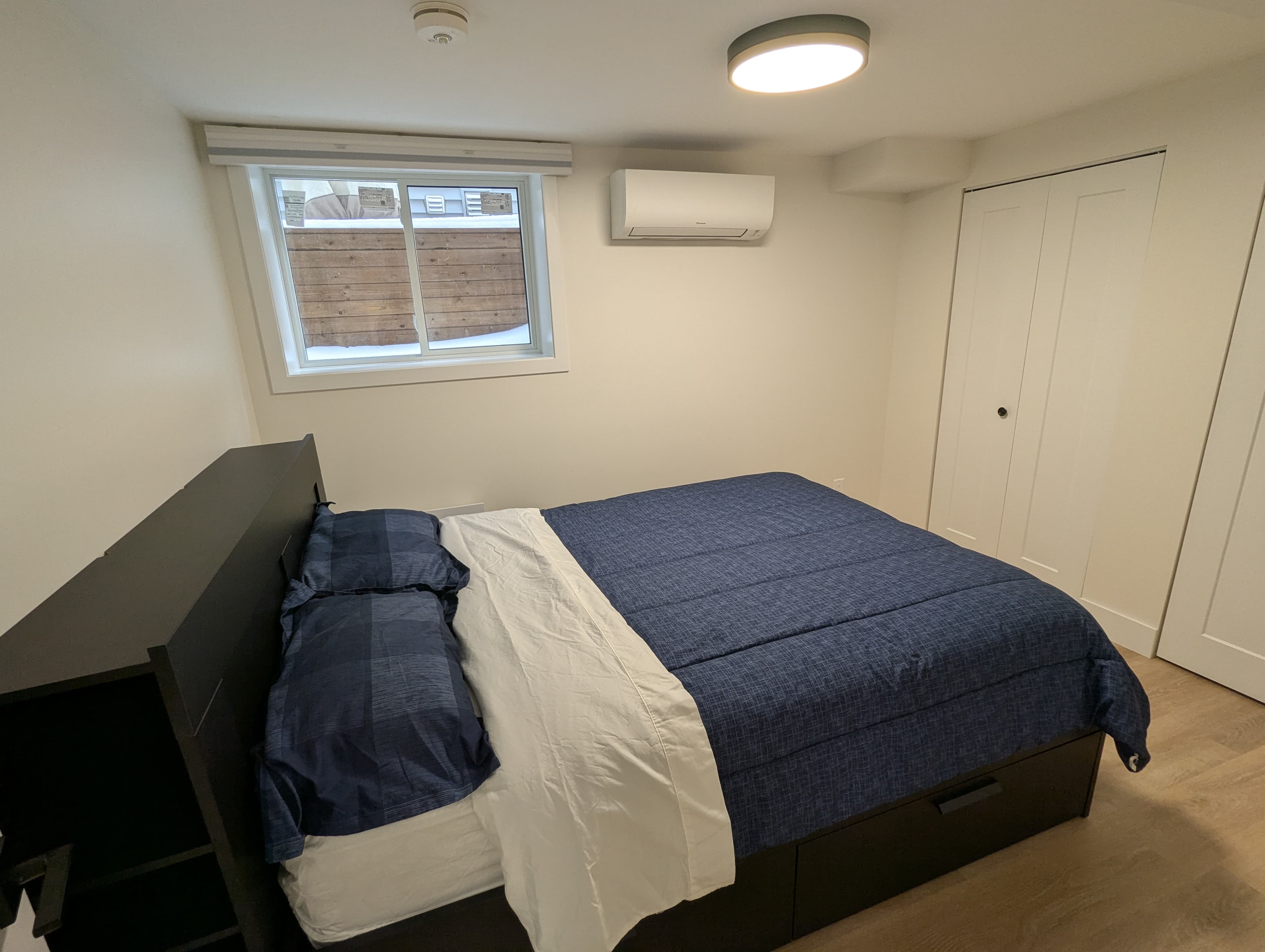 Bedroom with queen bed and mini-split AC