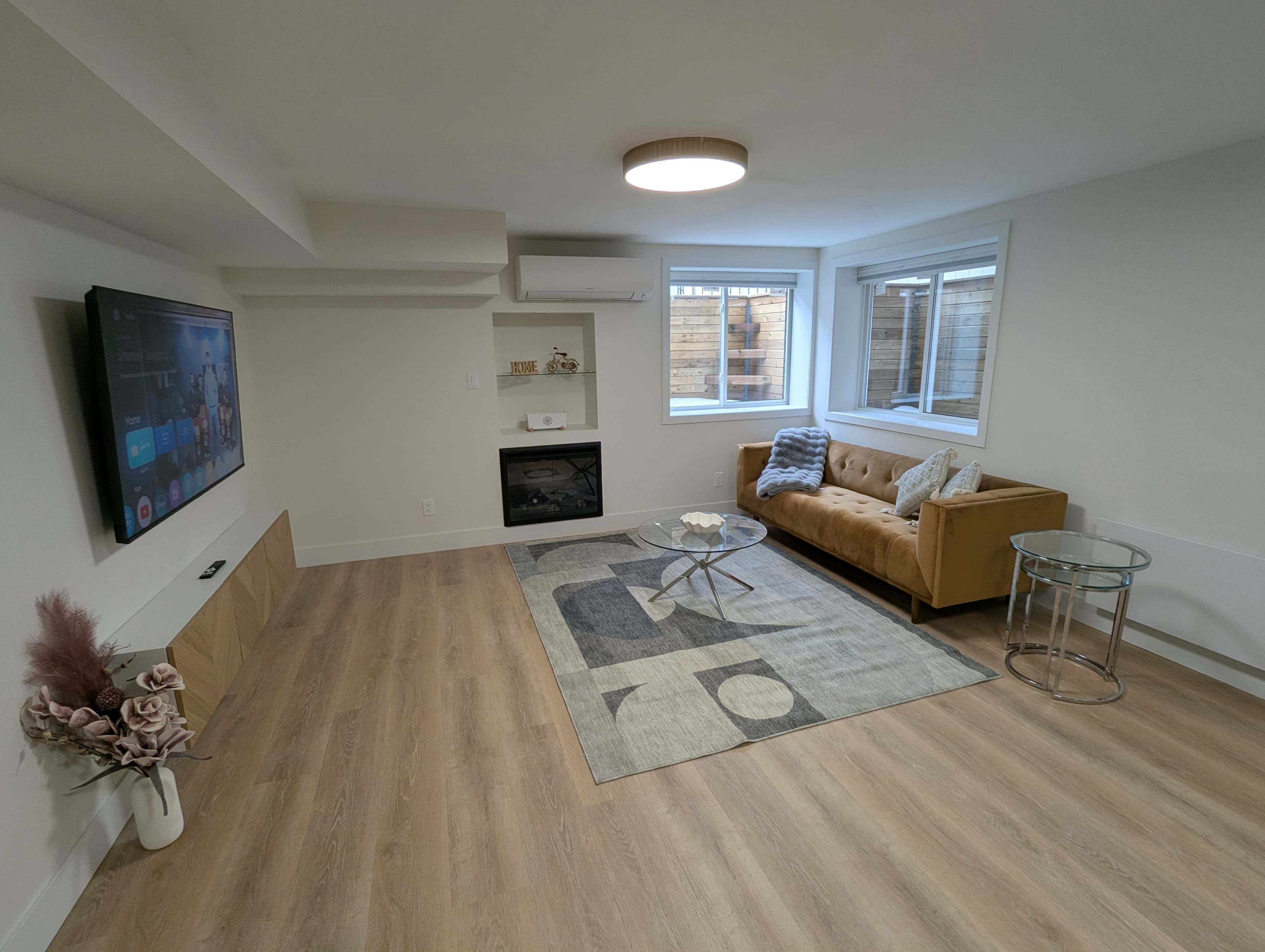 Living room with sofa, fireplace and smart TV
